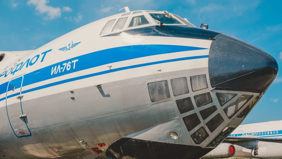 Close-up of IL-76T cargo aircraft displaying iconic Aeroflot branding at a sunny airfield.
